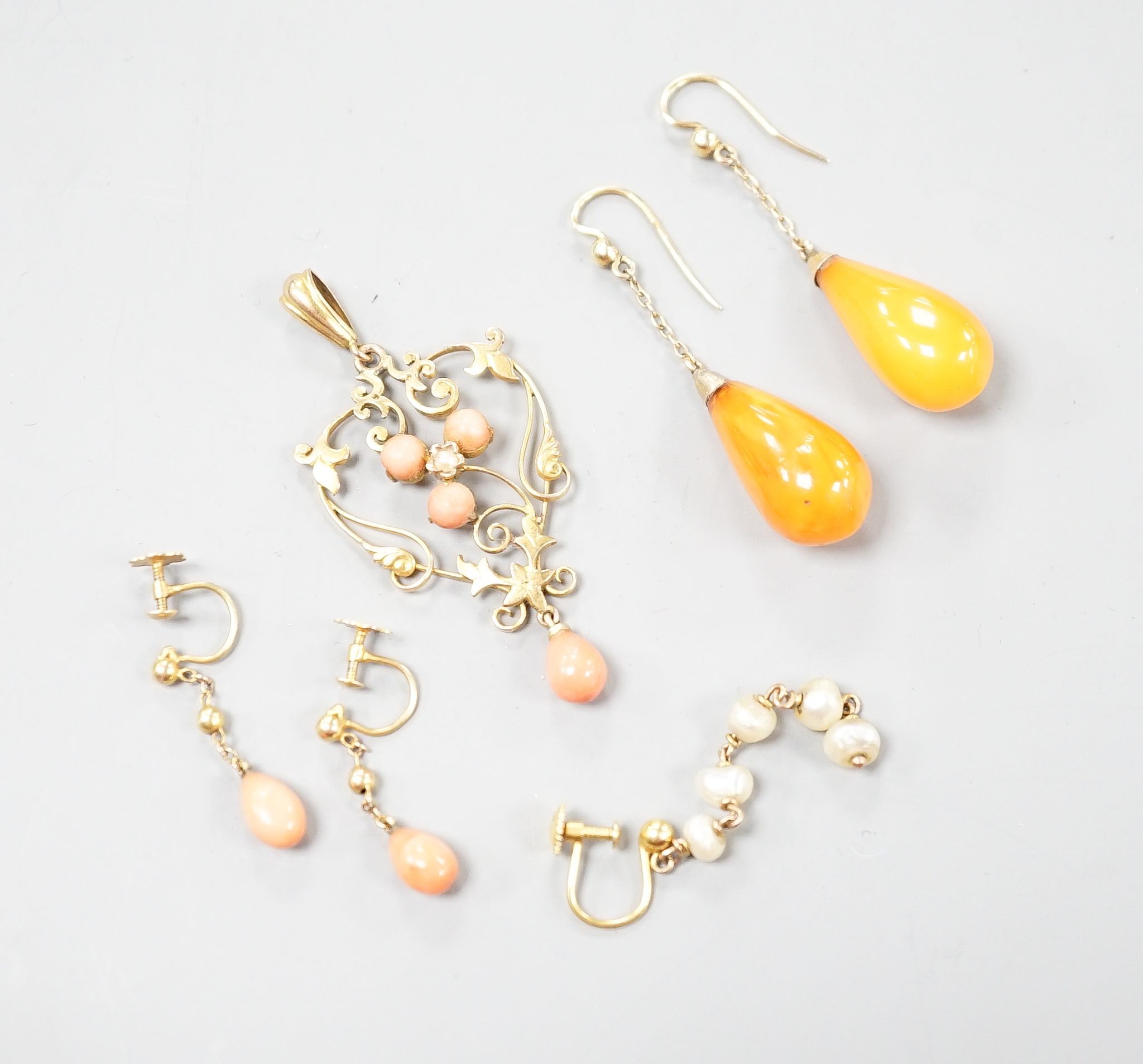 A gold and coral mounted pendant and coral earrings and a pair of amber and gold earrings